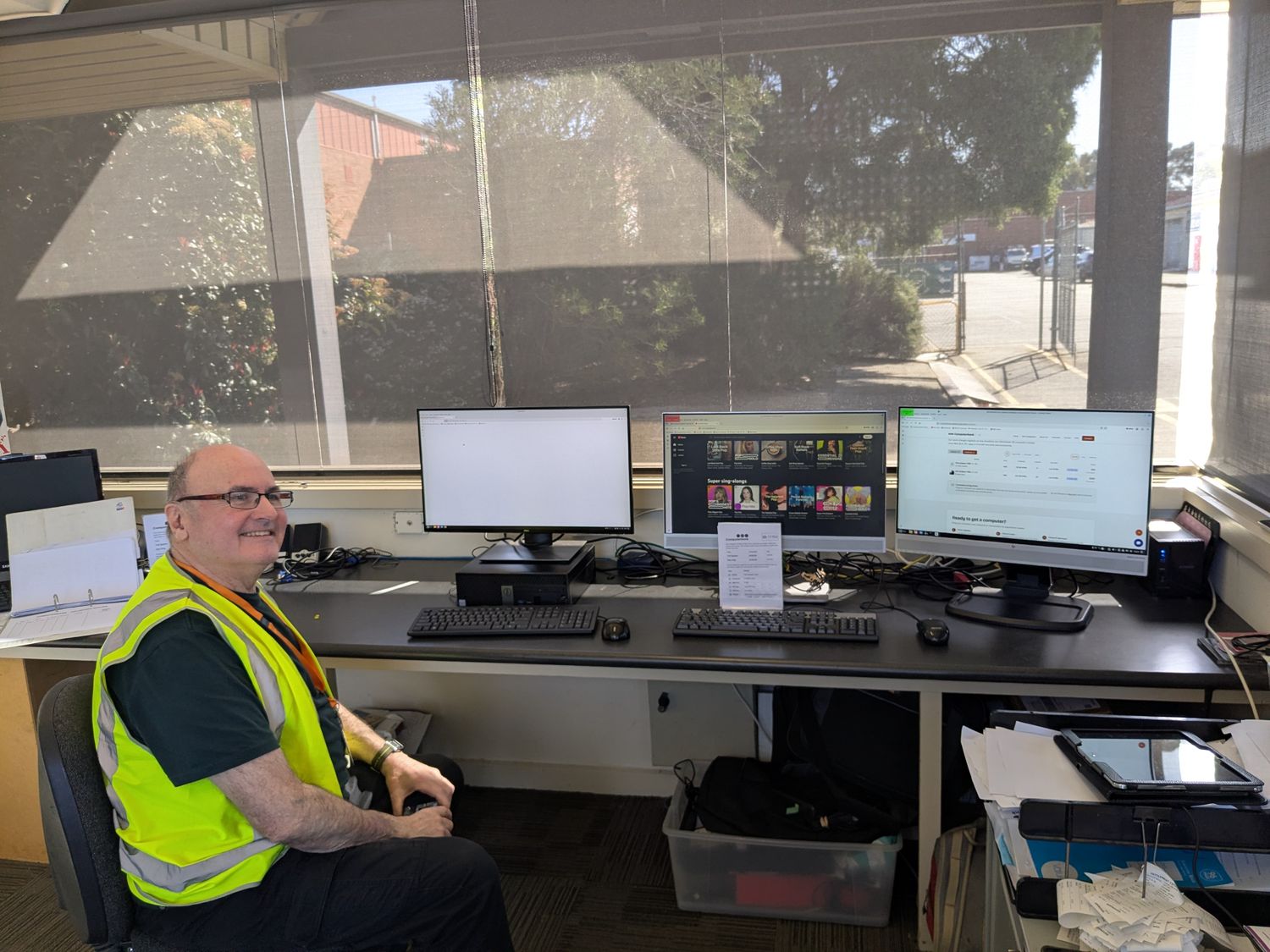 A volunteer at the front desk computers in the Broadmeadows showroom
